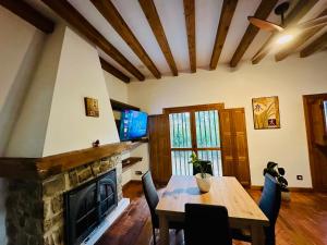 a living room with a table and a fireplace at La Mansion de Gallegos in Gallegos