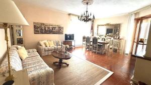 a living room with a couch and a table at La Via delle Rose in Tempio Pausania