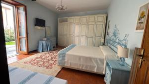 a bedroom with two beds and a television in it at La Via delle Rose in Tempio Pausania