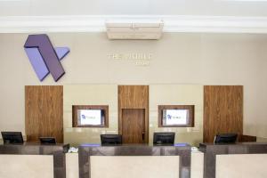 a waiting room with a k sign on the wall at Studio Completo - Vila Olímpia - Moema in Sao Paulo +28 photos