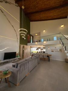 a large living room with a couch and a table at Casa Som das Ondas in Fortim