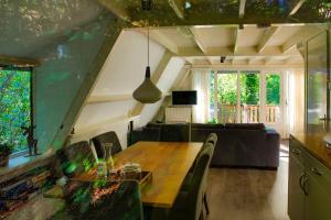 a living room with a table and a couch at Boshuisje Durbuy met zwembad op het park in Durbuy