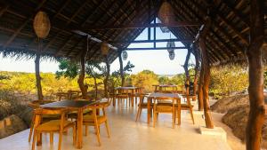 a group of tables and chairs in a restaurant at Enchanted Escapes Yala in Yala +18 photos