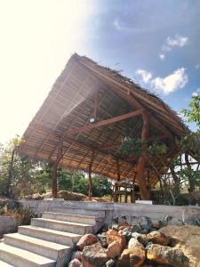 a straw roofed building with stairs and rocks at Enchanted Escapes Yala in Yala