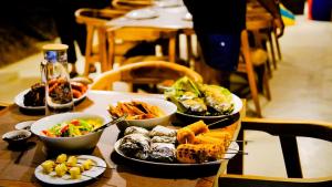 a table with four plates of food on it at Enchanted Escapes Yala in Yala