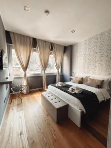 a bedroom with a large bed and two windows at VB's Luxury Flat in Rome