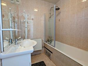 a bathroom with a sink and a shower and a tub at Maison de Caractère pour 12, Proche Gérardmer & Thermes, Nature et Confort - Bellefontaine - FR-1-589-40 in Bellefontaine +27 photos