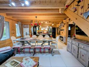a kitchen and dining room with a table and chairs at Chalet Neuf Haut de Gamme avec Spa, Sauna et Décoration Originale – Gérardmer - FR-1-589-80 in Gérardmer