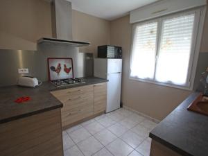 a kitchen with a white refrigerator and a window at Charmant apt avec accès indépendant, terrasse, proche Épinal et activités culturelles - FR-1-589-138 in Hagécourt