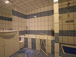 a bathroom with a tub and a sink and a shower at Gîte spacieux et confortable avec terrasse, proche activités montagne, à Ferdrupt - FR-1-589-146 in Ferdrupt +10 photos