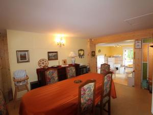 a dining room and kitchen with a table and chairs at Gîte Confortable en Pleine Forêt avec Étang, Idéal pour Familles et Amis - FR-1-589-154 in Barbey-Séroux