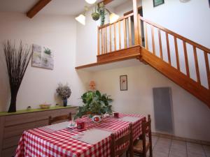 a dining room with a table and a staircase at Gîte confortable en montagne avec terrasse, idéal pour rando et cure, proche de Plombières-les-Bains - FR-1-589-172 in Le Val-dʼAjol