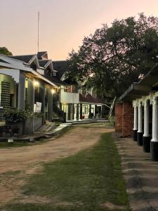 a row of houses with a dirt road at North Coast Gateway Hotel in Kwambonambi