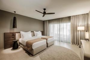 a bedroom with a bed and a ceiling fan at AX The Heights Residences - Adults Only in Ħal-Bajjada +19 photos