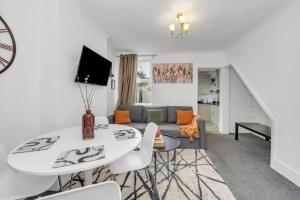 a living room with a table and a couch at Wherstead Rd House By Homestyles Hosts Short Lets & Serviced Accommodation Suffolk With Free Parking in Ipswich
