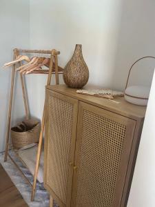 a wooden cabinet with a vase on top of it at The best view in Marezige