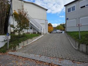 a cobblestone street in front of a building at Container-Apartment in Munich +2 photos