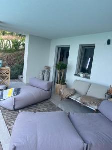 a living room with purple couches in a room at The best view in Marezige