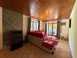 ein Wohnzimmer mit Sofa und Fernseher in der Unterkunft Maison spacieuse avec spa, ping-pong et baby-foot, idéale pour détente en famille - FR-1-589-828 in La Chapelle-aux-Bois