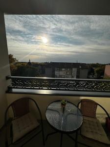 a table and chairs on a balcony with a view at Apartment Athens 2 in Sombor +4 photos