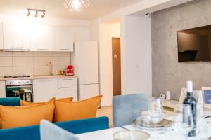 a kitchen and dining room with a table and chairs at DREAMS ESCAPE 2 in Craiova
