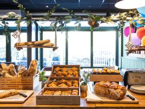 a bakery with many different types of bread and pastries at ibis Bordeaux Pessac Route des Vins in Pessac
