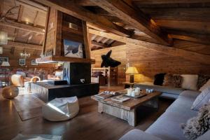 a living room with a couch and a table at Chalet Patagonia - OVO Network in La Clusaz