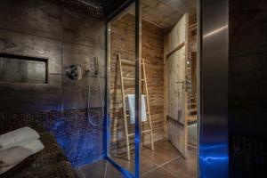 a shower with a glass door in a bathroom at Chalet Patagonia - OVO Network in La Clusaz