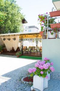 a patio with pink flowers in a yard at DebiMar in Chernomorets