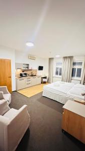 a large bedroom with two beds and a couch at Hotel PAYER in Teplice