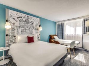 a hotel room with a large bed and a desk at Hôtel Mercure Paris Centre Gare Montparnasse in Paris +154 photos