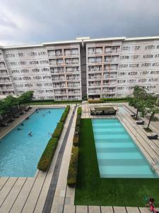 a large apartment building with a large swimming pool at Trees Residences Staycation in Manila