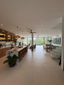 an open kitchen and dining area of a house at Elements Villa B1 - Rooftop, Pool & 5-Min to Beach in Bingin Beach