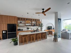 a kitchen with a large island in a living room at Elements Villa B1 - Rooftop, Pool & 5-Min to Beach in Bingin Beach