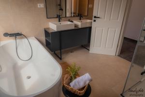 ein Badezimmer mit einer weißen Badewanne und 2 Waschbecken in der Unterkunft Discover Lastovo premium accommodation in Skrivena Luka