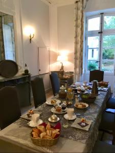 a dining room table with food on it at Château De Jouques in Gémenos