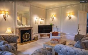 a living room with two couches and a fireplace at Denham Mount in Buckinghamshire