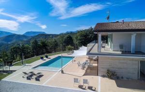 a house with a swimming pool and mountains in the background at Villa Montefalcone 8 by Marche Holiday Villas in Acqualagna