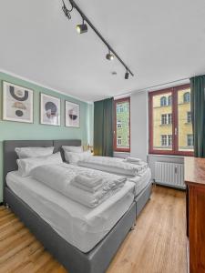 a bedroom with two beds and two windows at Flatista Homes - Herzog Heinrich in Munich