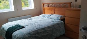 a bedroom with a bed and a dresser at Home stay in Basingstoke