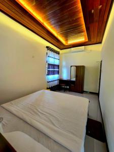a bedroom with a white bed and a window at Forina Villa in Walliwala East +3 photos