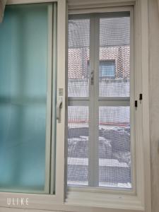 a sliding glass door with a view of a building at Stay179 Guesthouse - Female only in Seoul +23 photos