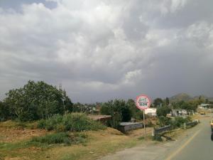 a speed limit sign on the side of a road at GC Hotel & Banquet Hall in Dargai