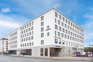 a white building on the corner of a street at Premier Inn Rosenheim City Lokhöfe in Rosenheim