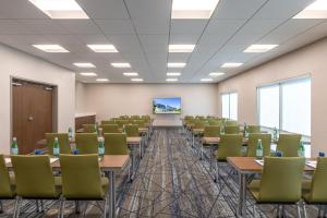 an empty room with tables and chairs in a classroom at Holiday Inn Express & Suites Greenwood Mall by IHG in Greenwood +55 photos