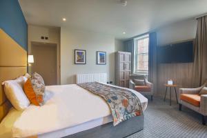 a hotel room with a bed and a chair at Royal Whitby in Whitby +48 photos