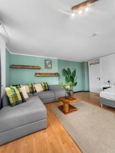a living room with a couch and a table at Flatista Homes - Herzog Heinrich in Munich