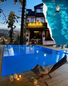 a swimming pool in front of a house at Goldener Hahn B&B Baiersbronn - Ferienwohnungen mit Hygge Pool & Sauna in Baiersbronn