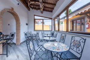 a patio with tables and chairs and windows at Il Piccolo Borghetto in Rome