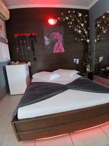 a bedroom with a large bed in a room at Motel A 2 in Criciúma